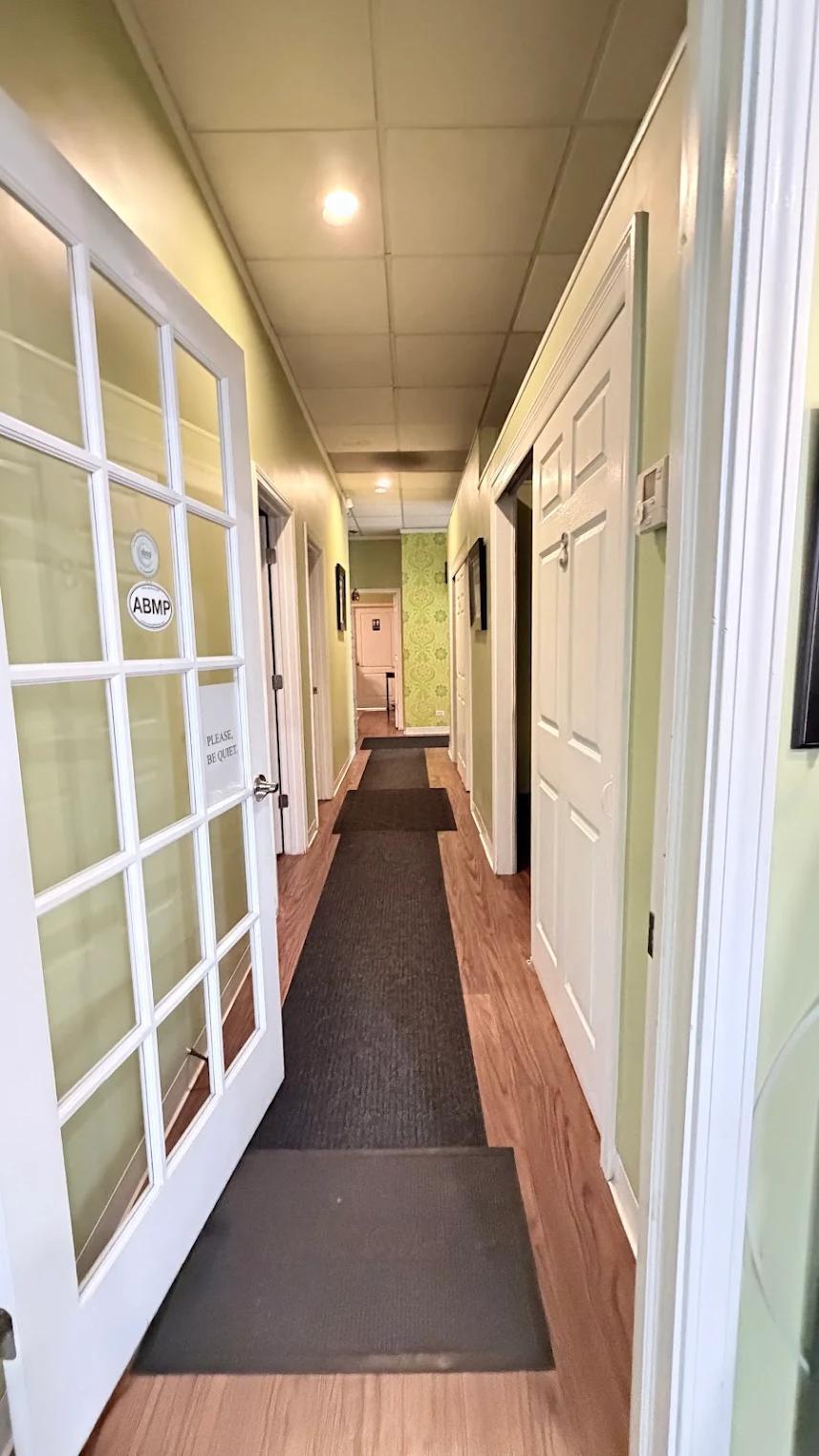A quiet hallway leading to private treatment rooms